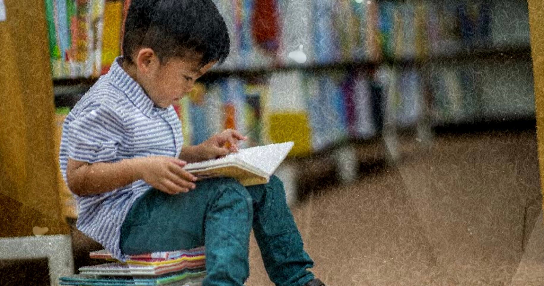 A young child absorbed in a book among library shelves — the moment Slumberkins is built for